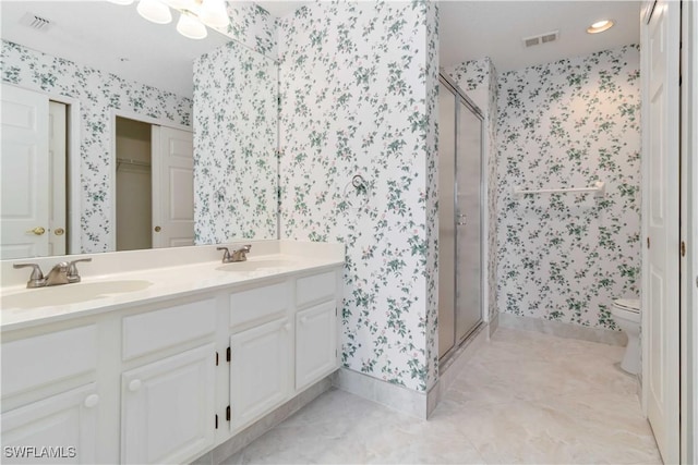 bathroom with visible vents, wallpapered walls, and a sink