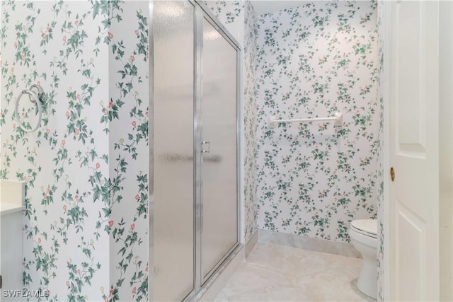 bathroom featuring tile patterned flooring, a shower stall, toilet, and wallpapered walls