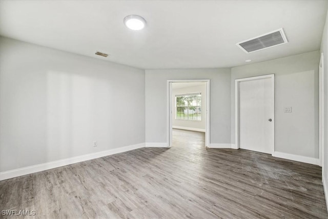 unfurnished room featuring dark wood-type flooring