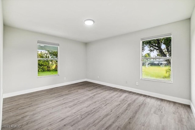 spare room with wood-type flooring