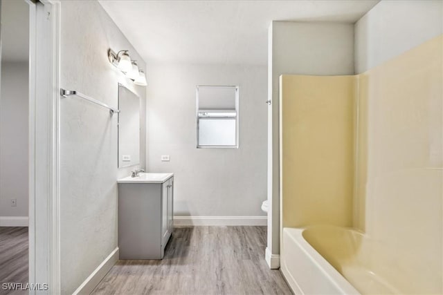 bathroom with vanity, wood-type flooring, and toilet