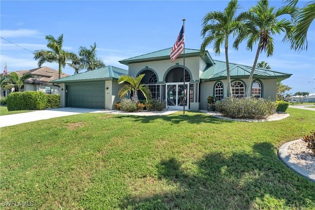 view of front of property with a front yard and a garage