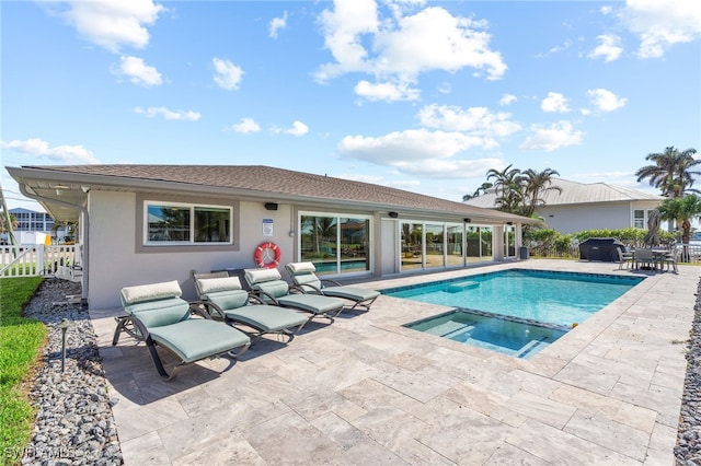 view of pool featuring a patio area and an in ground hot tub