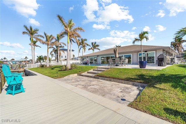 view of community with a yard and a patio