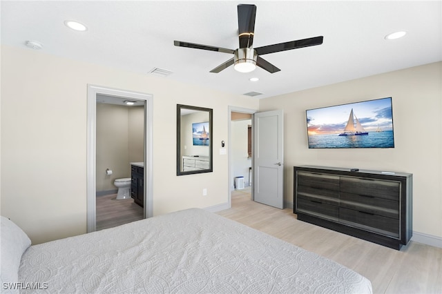 bedroom featuring light hardwood / wood-style floors, ensuite bath, and ceiling fan