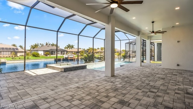 view of pool with ceiling fan, a lanai, a jacuzzi, and a water view