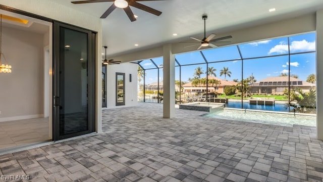 view of pool with a patio, ceiling fan, and a lanai