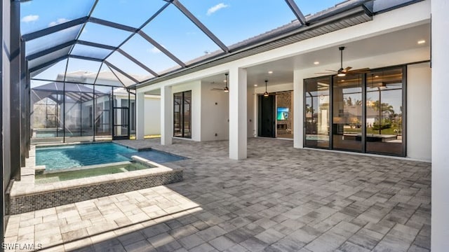 back of house featuring ceiling fan, a patio area, and glass enclosure