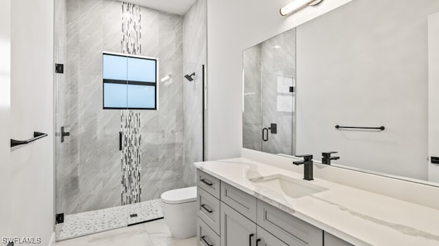 bathroom featuring vanity, toilet, and an enclosed shower