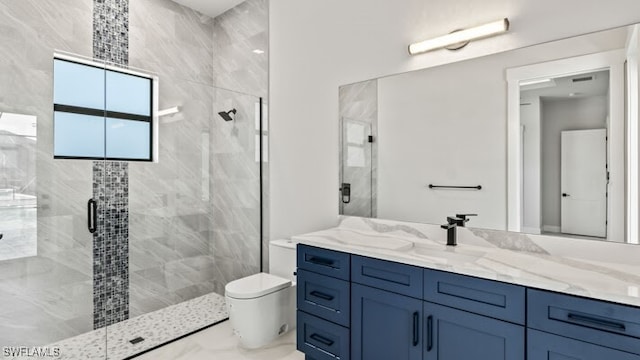 bathroom featuring vanity, toilet, and a shower with door