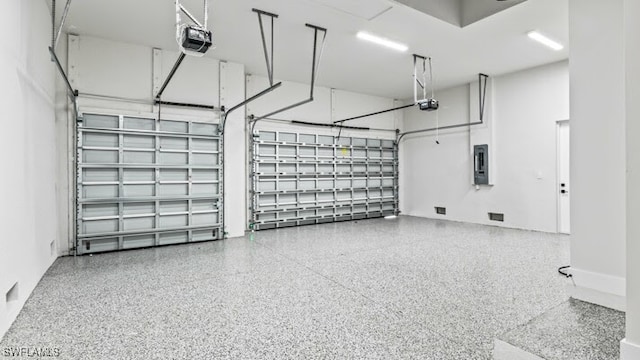 garage featuring electric panel and a garage door opener