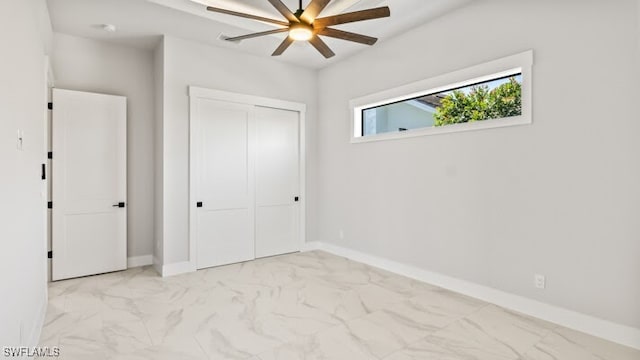 unfurnished bedroom with a closet and ceiling fan