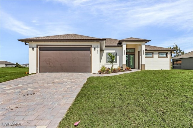 prairie-style house with a front yard and a garage