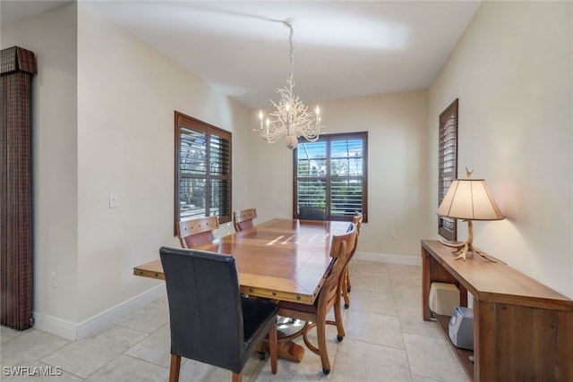 dining room featuring baseboards, light tile patterned floors, and an inviting chandelier