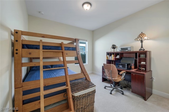 bedroom featuring light carpet and baseboards