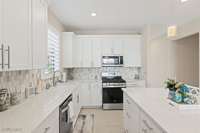 kitchen with white cabinetry, sink, pendant lighting, and appliances with stainless steel finishes