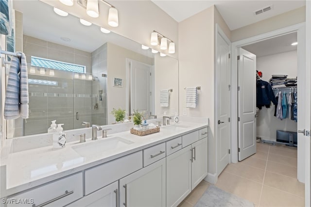 bathroom featuring walk in shower, tile patterned floors, and vanity