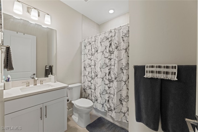 bathroom featuring tile patterned flooring, vanity, and toilet