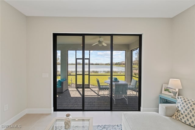 tiled bedroom with access to exterior and a water view