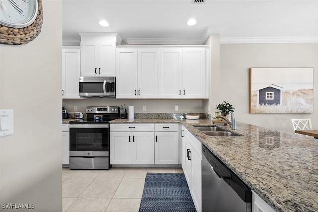 kitchen with light stone countertops, white cabinetry, sink, crown molding, and appliances with stainless steel finishes