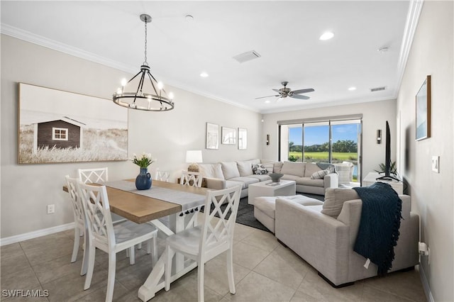 tiled dining space featuring ceiling fan with notable chandelier and crown molding