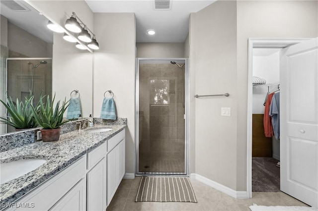 bathroom with tile patterned flooring, vanity, and an enclosed shower