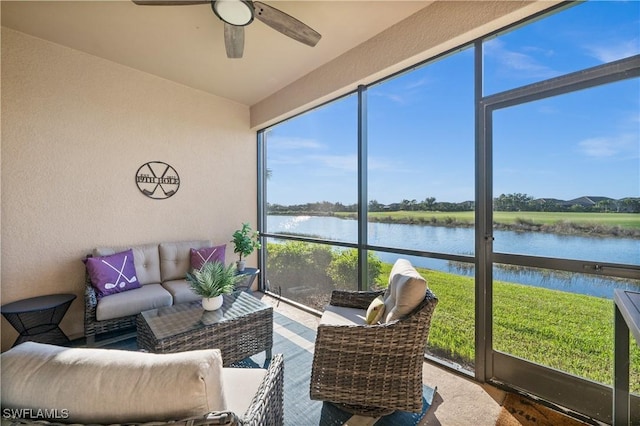 sunroom featuring a water view, plenty of natural light, and ceiling fan