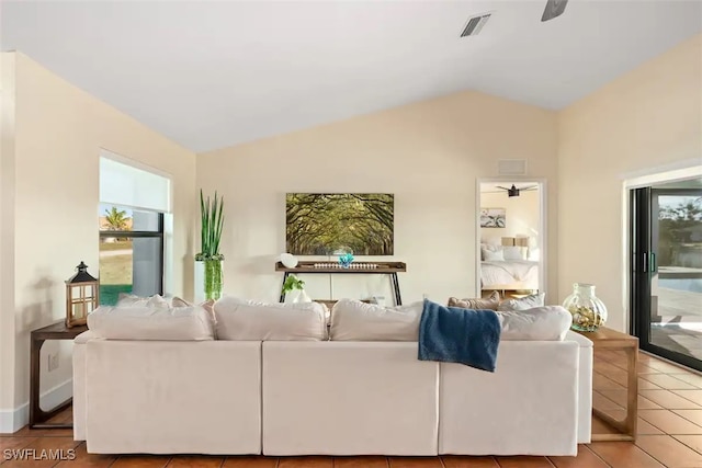 tiled living room featuring visible vents and lofted ceiling