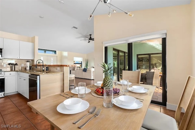 tiled dining room featuring ceiling fan and sink