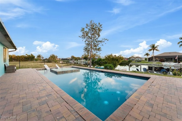 view of swimming pool featuring a water view and a patio area