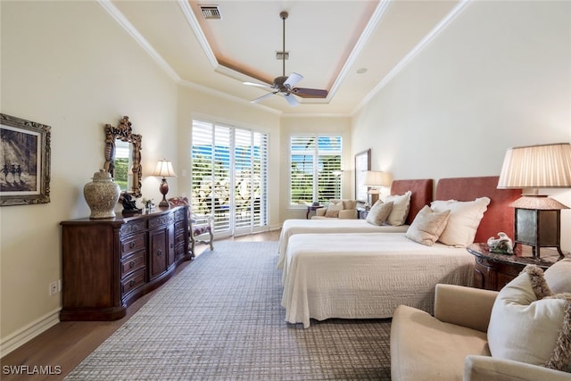 bedroom with a tray ceiling, access to outside, ceiling fan, crown molding, and wood-type flooring