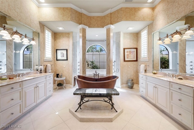 bathroom with ornate columns, plenty of natural light, and ornamental molding