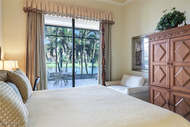 bedroom with access to outside, a water view, and ornamental molding