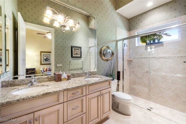 bathroom featuring vanity, a shower with door, ceiling fan, tile patterned flooring, and toilet