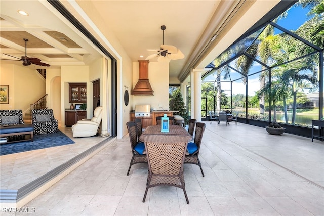 exterior space featuring ceiling fan, a grill, a lanai, and exterior kitchen