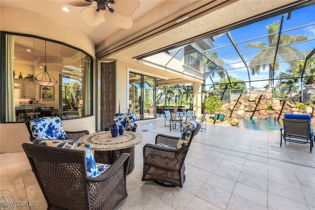 view of patio / terrace featuring glass enclosure, ceiling fan, and an outdoor living space