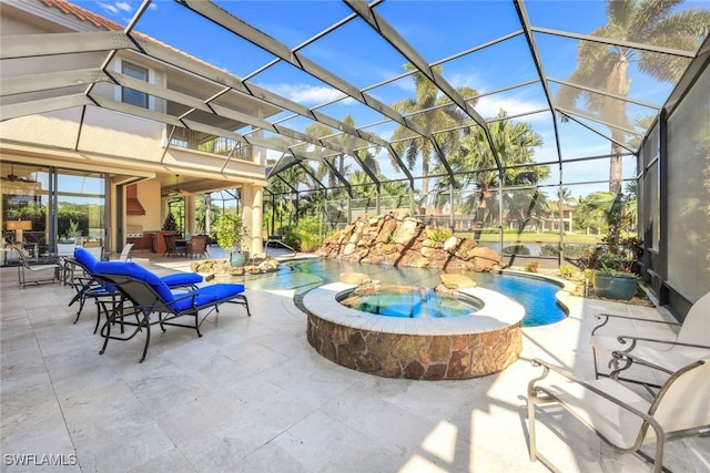 view of patio / terrace featuring a lanai and a pool with hot tub