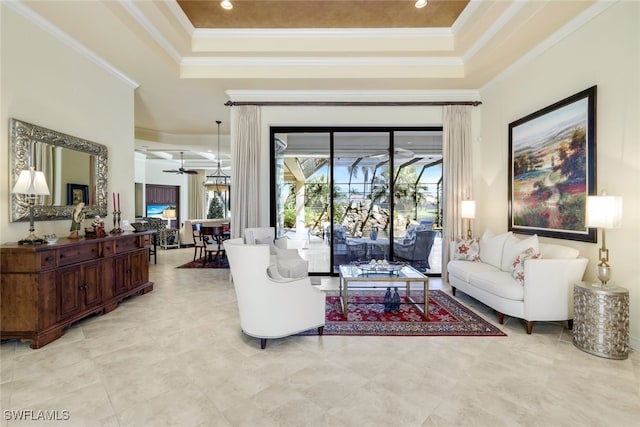 living room featuring a raised ceiling, crown molding, and ceiling fan