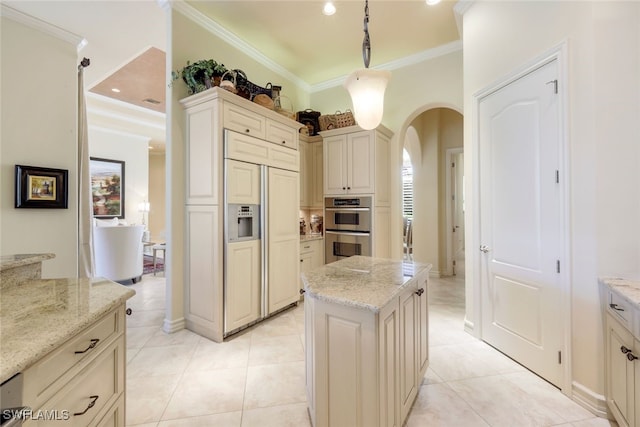 kitchen with paneled built in refrigerator, decorative light fixtures, light stone counters, and double oven