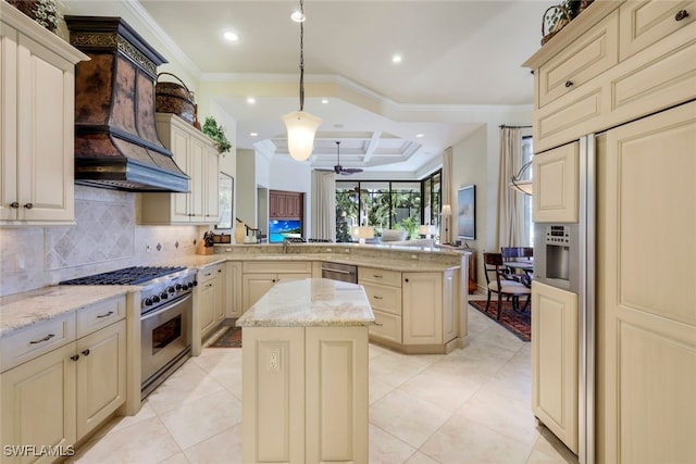 kitchen featuring kitchen peninsula, cream cabinets, a center island, and premium appliances