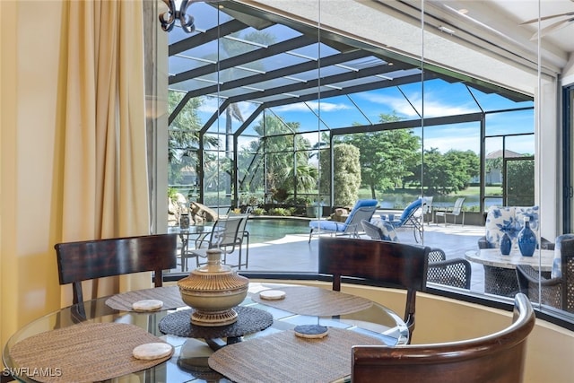 sunroom featuring a pool, a wealth of natural light, and a chandelier