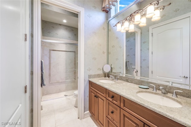 bathroom featuring tile patterned flooring, vanity, tiled shower, and toilet