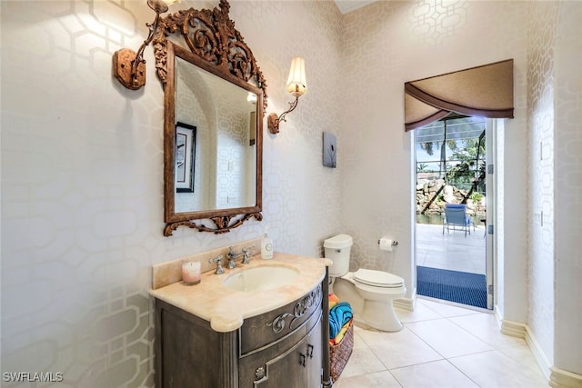 bathroom featuring tile patterned flooring, vanity, and toilet