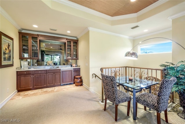 bar with a healthy amount of sunlight, crown molding, and light carpet