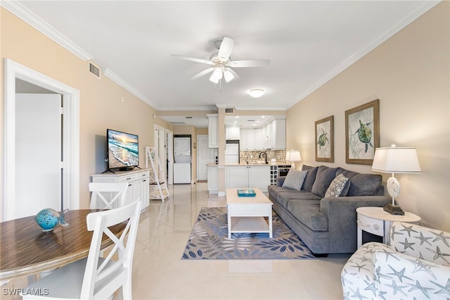 living room featuring ceiling fan and ornamental molding