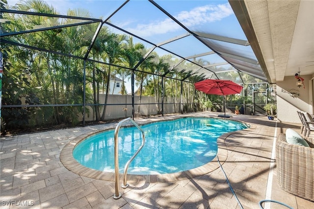 view of swimming pool with a patio area and glass enclosure