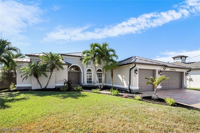 view of front facade with a garage and a front lawn