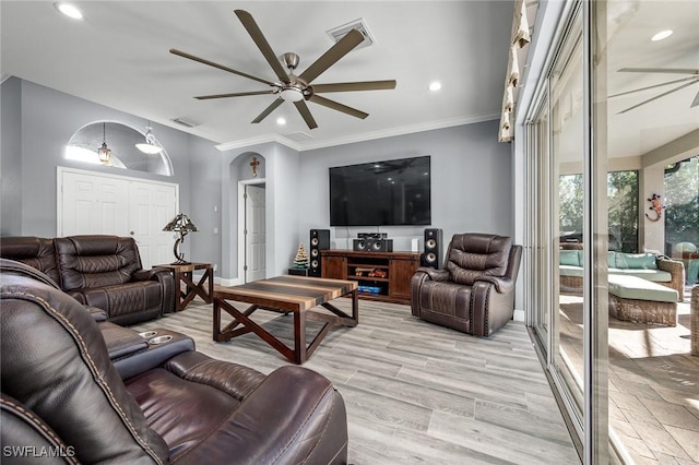 living room featuring ceiling fan, light hardwood / wood-style floors, and ornamental molding