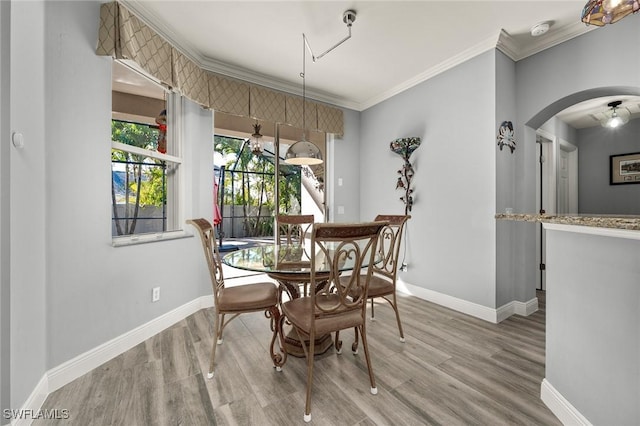 dining room featuring wood-type flooring and ornamental molding