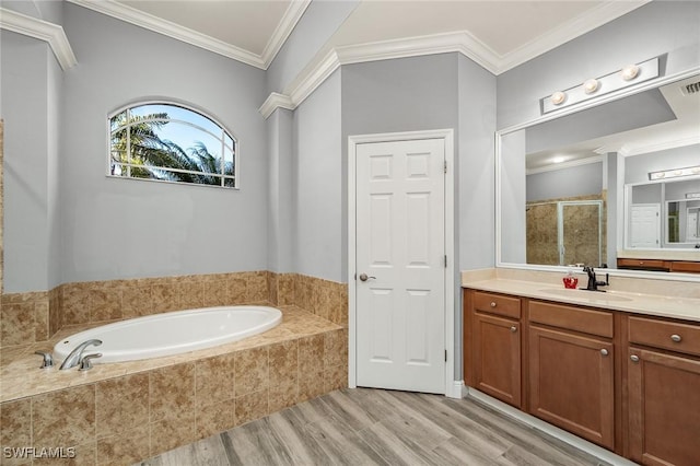 bathroom with crown molding, plus walk in shower, vanity, and hardwood / wood-style flooring